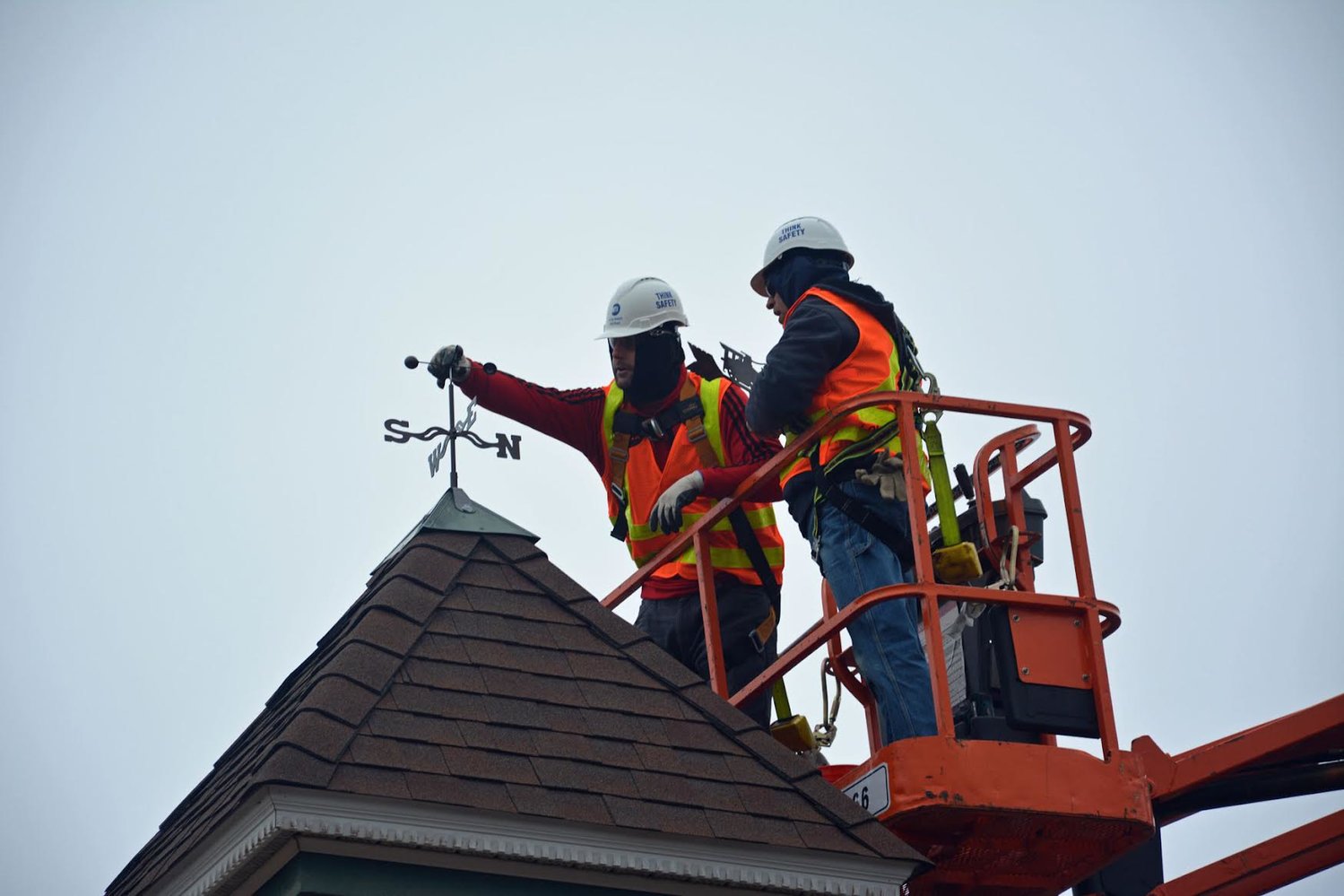 The LIRR structures department crew installing the new weathervane.